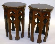 A pair of early 20th Century oak Indian style side tables of octagonal form and with carved panelled