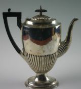 An Edwardian silver coffee pot. Mark of Walker & Hall. Of oval form with fluted decoration to