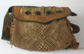 An early twentieth century hunting bag with leather body, crocheted front pouch, fur and hoof