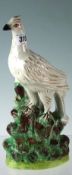 A Staffordshire figurine of a grouse on hillside, 12 ins (30.5 cms) high