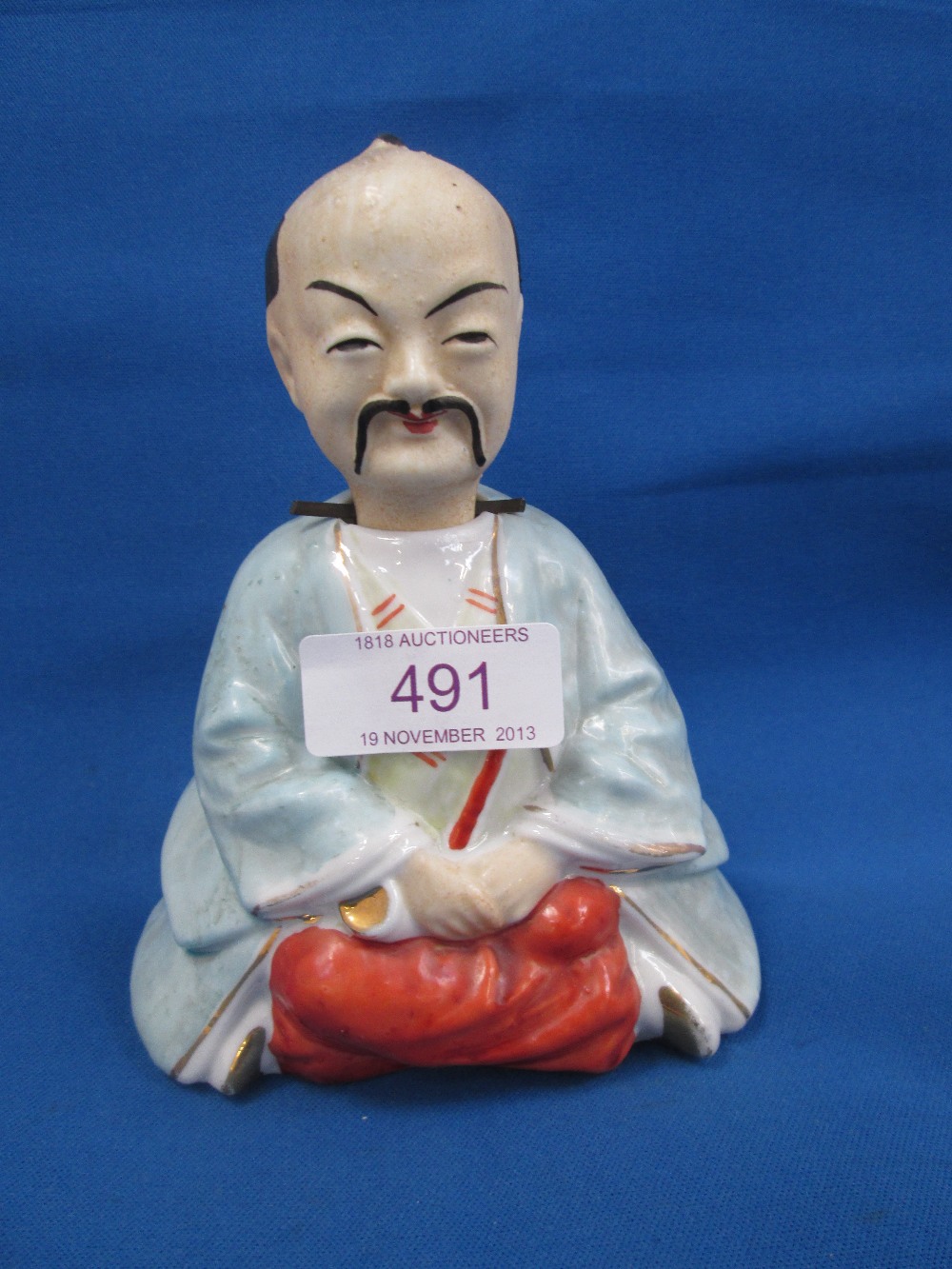 A 19th century nodder modelled as a seated Japanese man