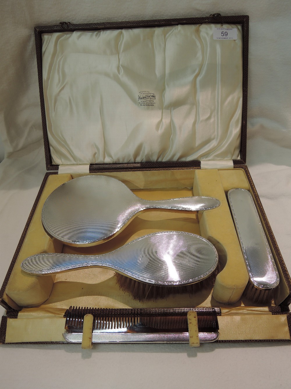 A cased silver backed dressing table mirror and brush set, Birmingham 1927