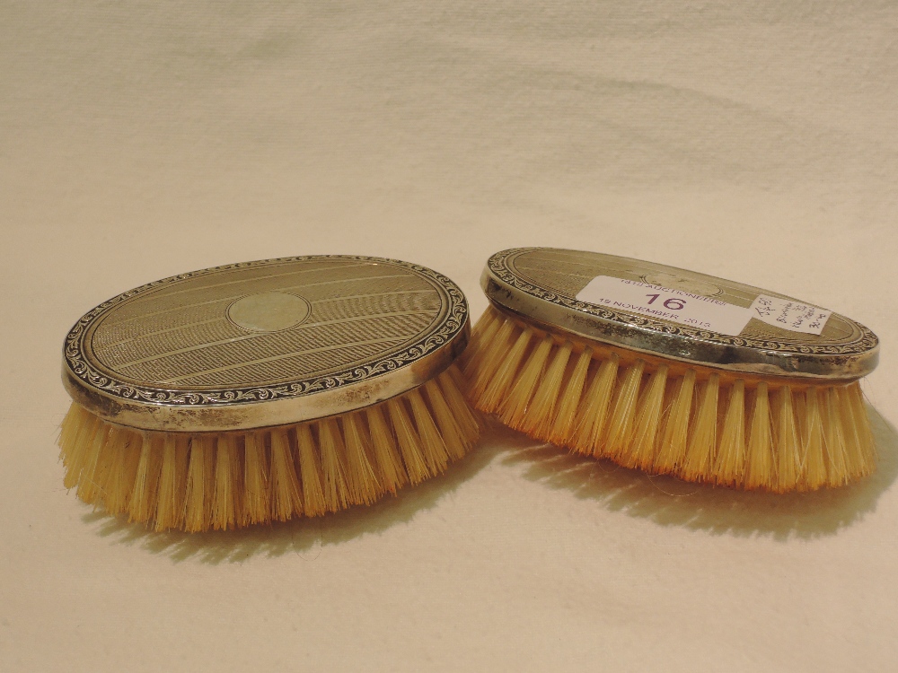 A pair of silver backed dressing table brushes, Birmingham 1926, Henry Matthews