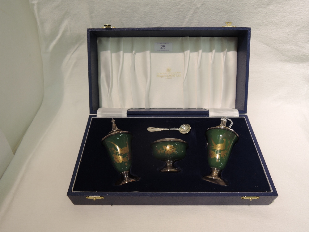 A cased silver plate and enamel cruet set, having gold and rouge Pheasant decoration on green