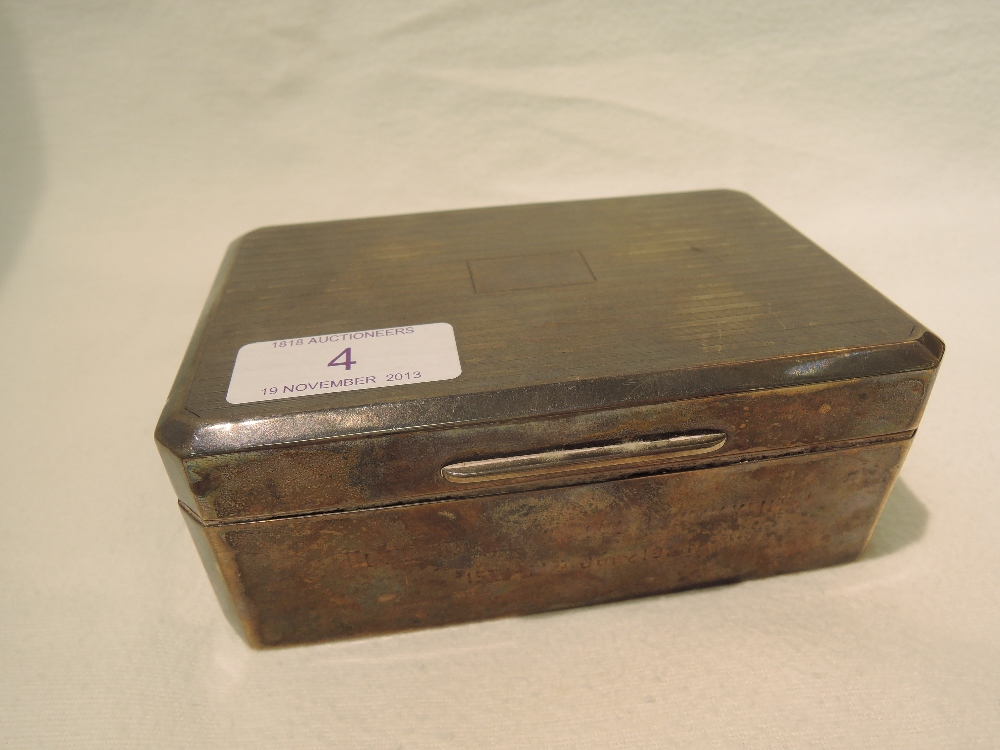 A silver cigarette box, having machined decoration to lid and inscription to side, Ulverston Golf