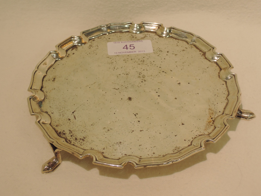 A silver card tray, on trefoil feet, London 1929, makers mark DGC, approx 166g