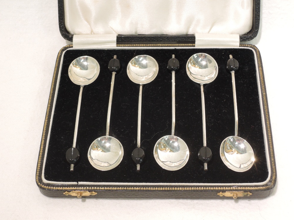 A cased set of silver coffee spoons, having bean knops, Birmingham 1933