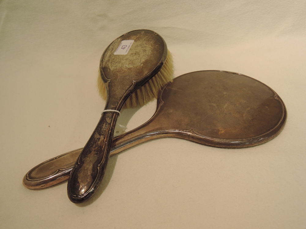 A silver backed dressing table mirror and brush, of plain form, Birmingham 1918