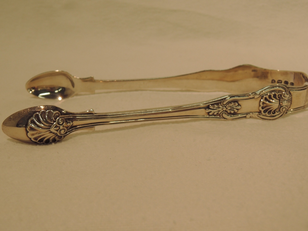 A pair of silver sugar tongs, in the Kings pattern, London 1829, makers mark IM, approx 69g