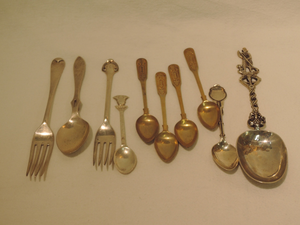 A selection of white metal decorative spoons etc