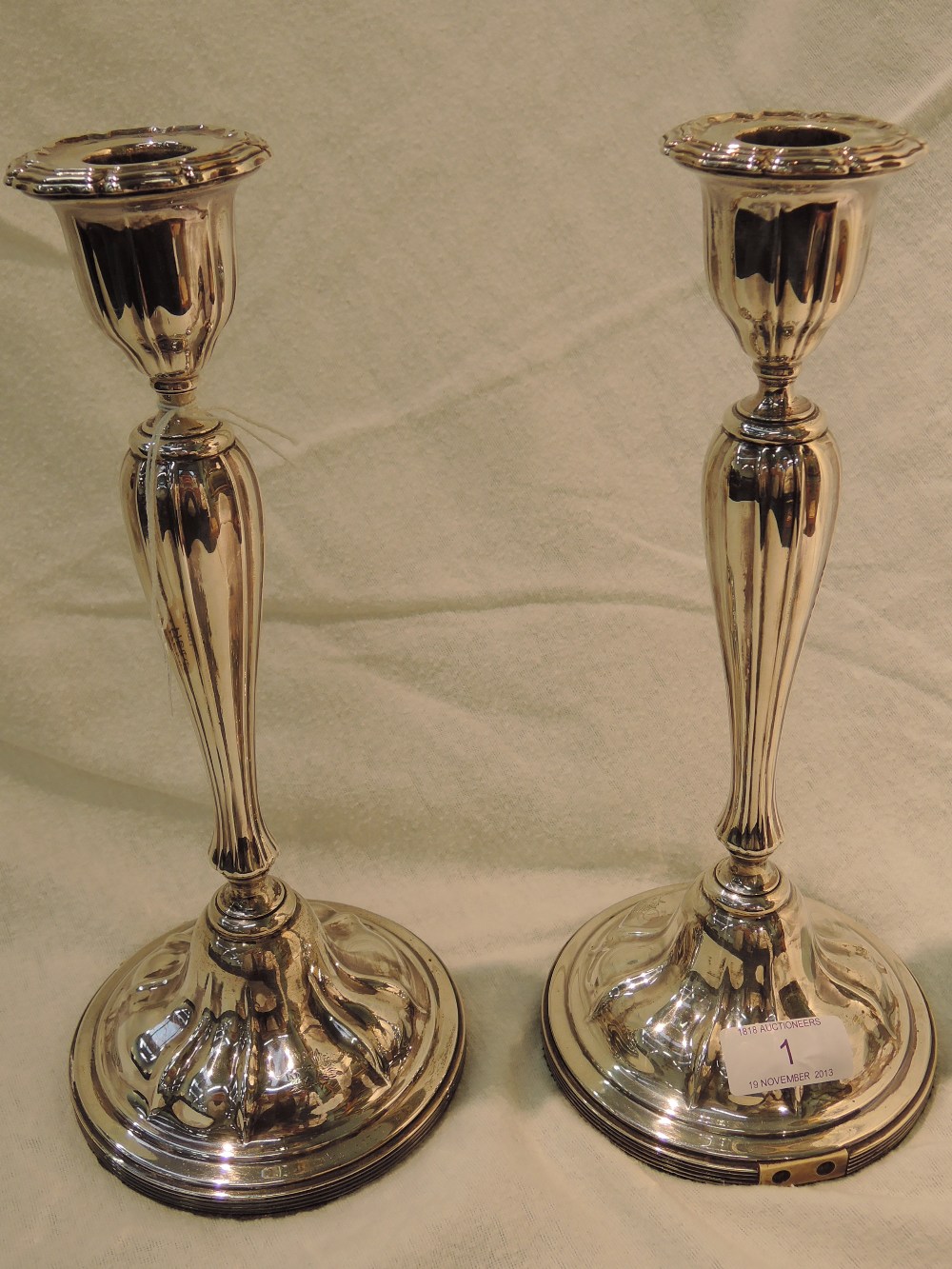 A pair of silver candlesticks, having weighted bases and later electrical fitments, Sheffield