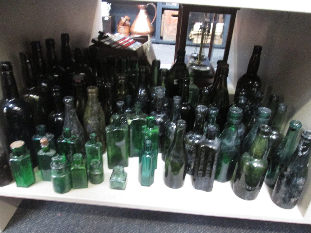 A selection of vintage green glass bottles, various