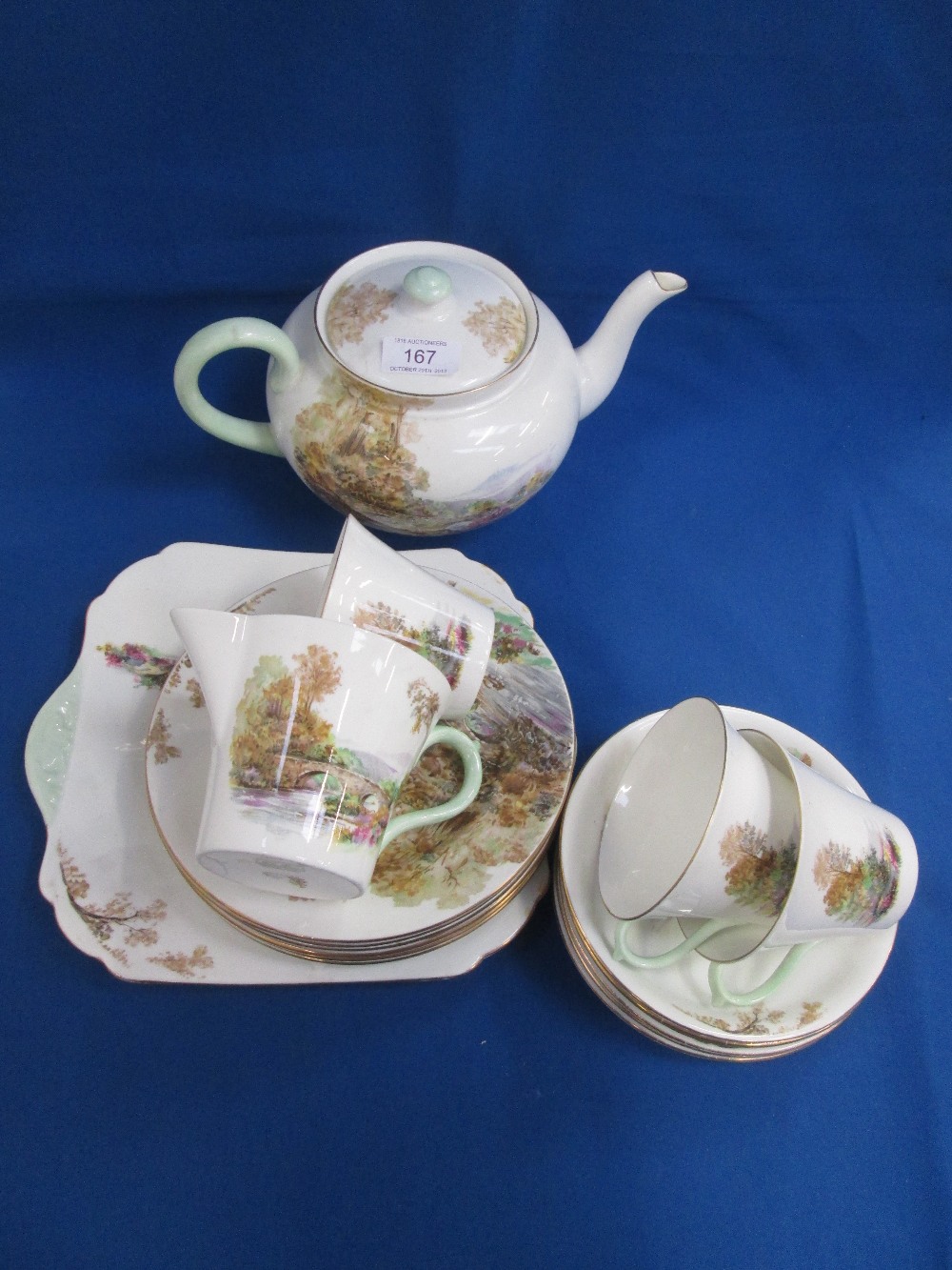 A Shelley tea service having pictorial landscape decoration, in the heather pattern