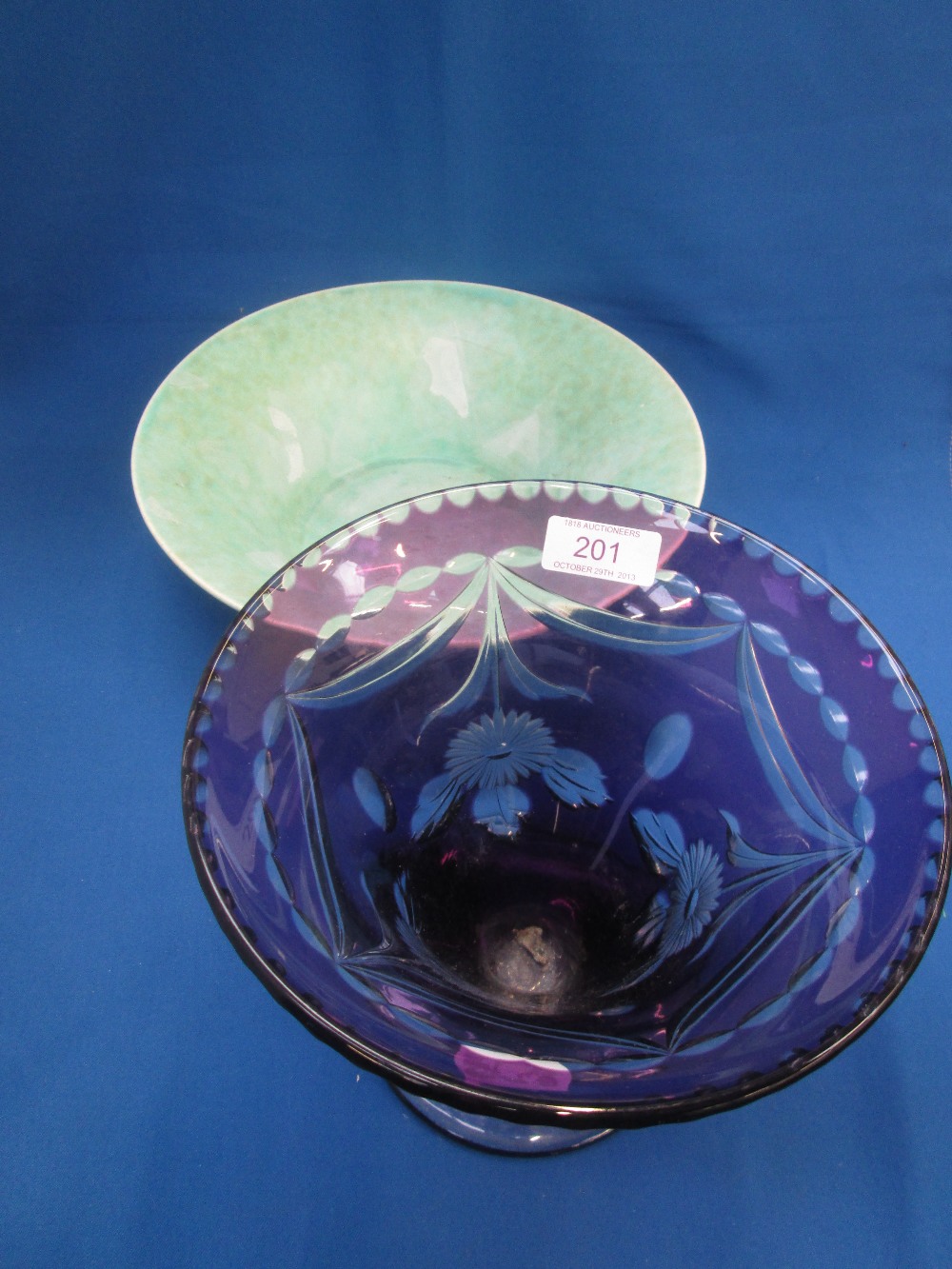 A Bohemian glass trumpet vase having clear floral decoration on purple ground on a black glass stand