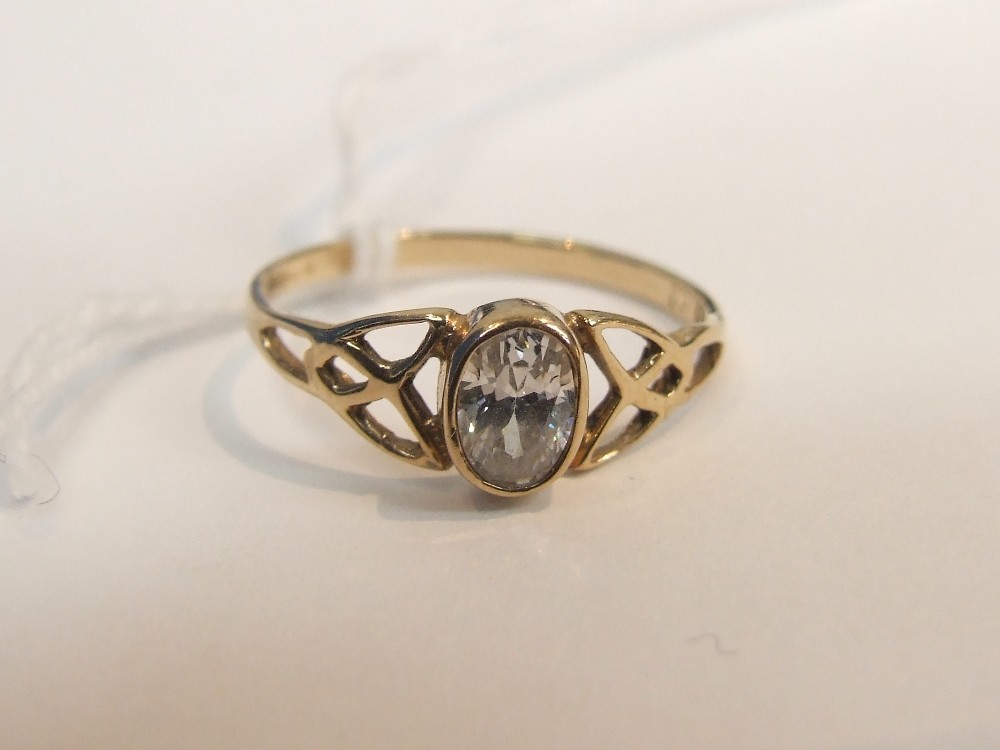 A ladies dress ring having oval cubic zirconia in a decorative open setting on a 9ct gold loop