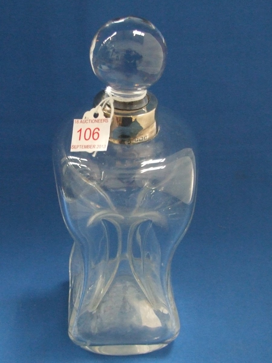 A glass decanter of dimple style having HM silver collar, marks worn