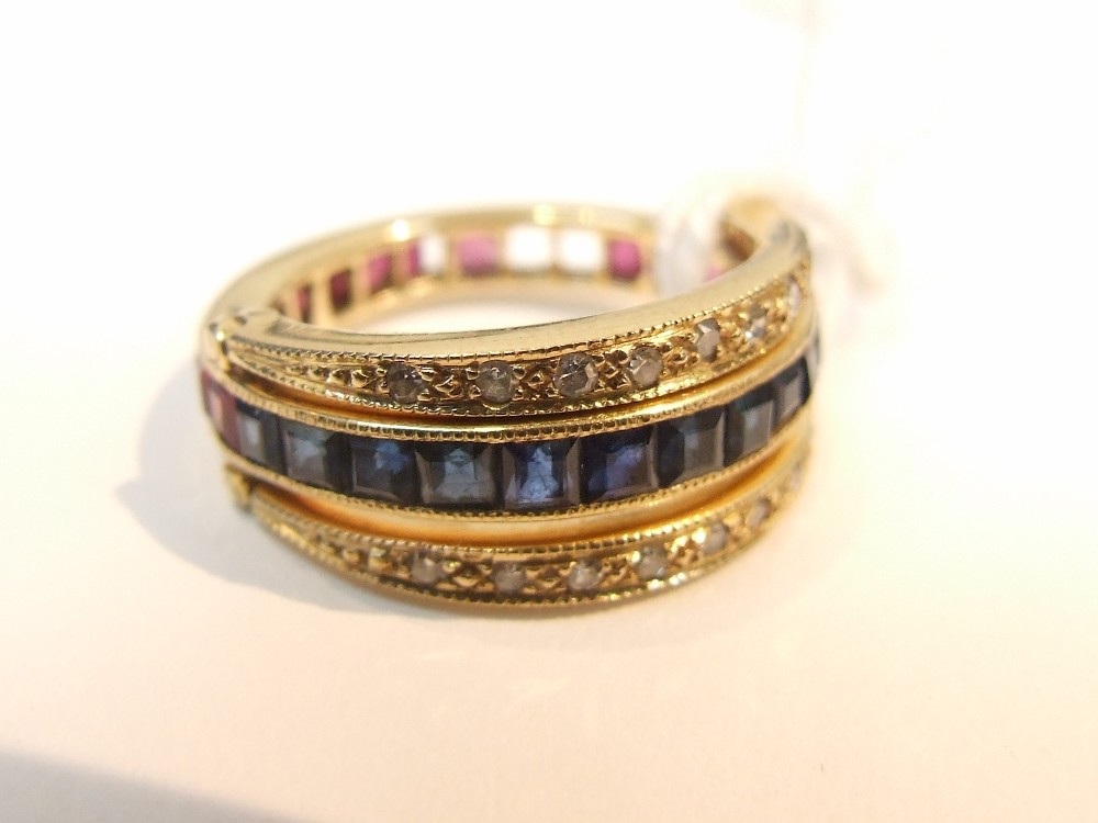 A full eternity ring with interchangeable bands set with rubies, sapphires and diamonds, set in