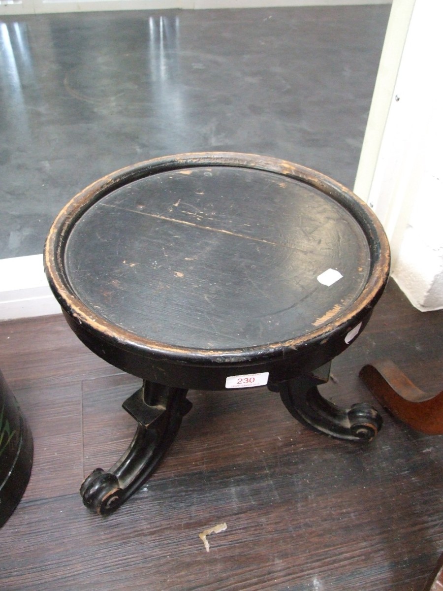 A Victorian black painted pedestal stand on triple scroll supports