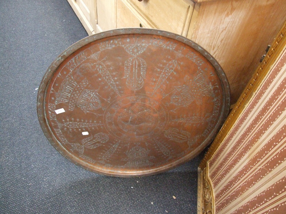 An Eastern copper tray/top having engraved decoration