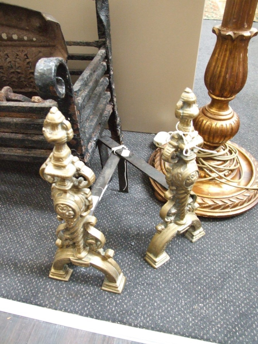 A pair of reproduction cast brass and iron fire dogs