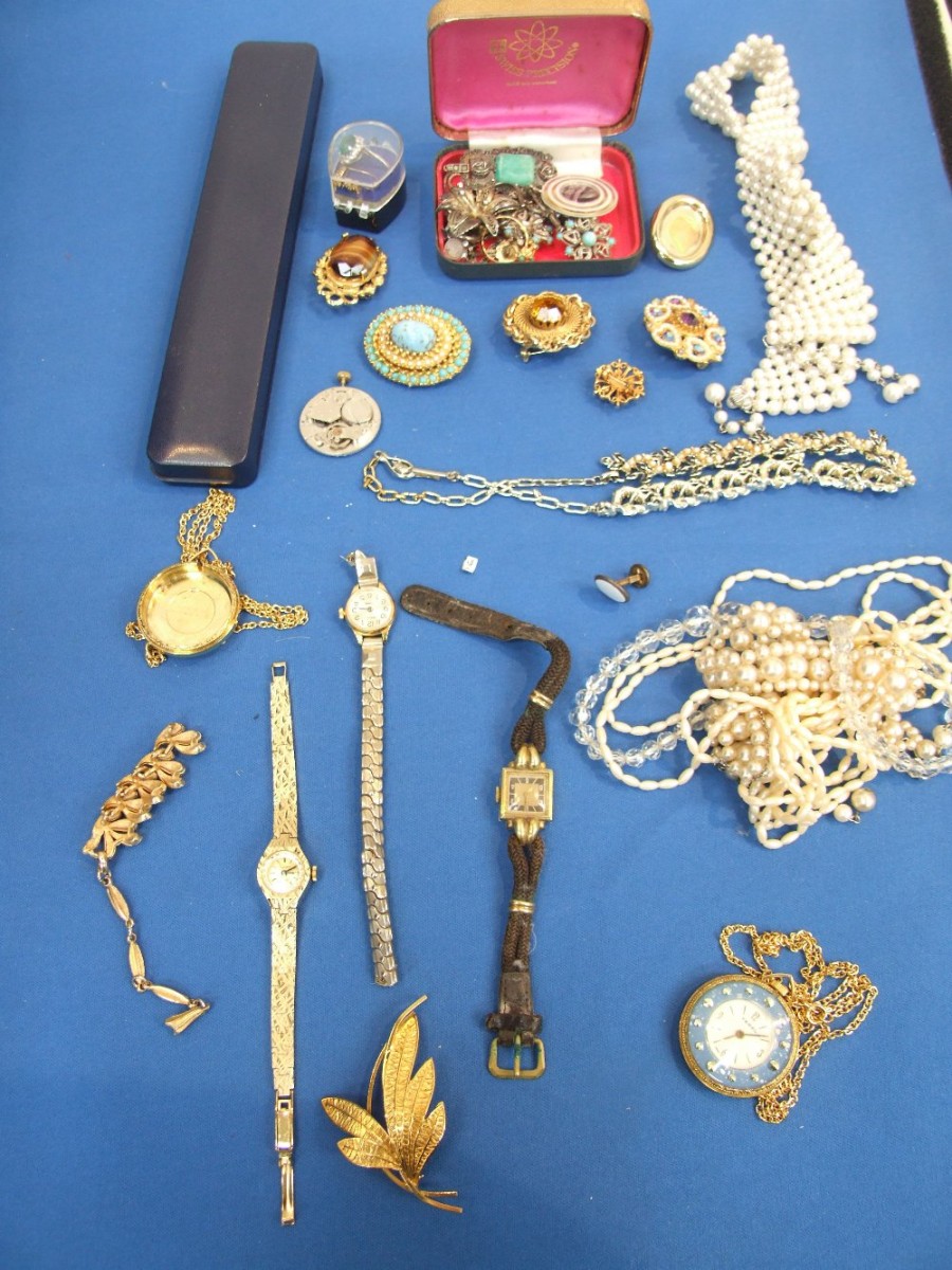 A selection of costume jewellery including white metal items, brooches, watches etc