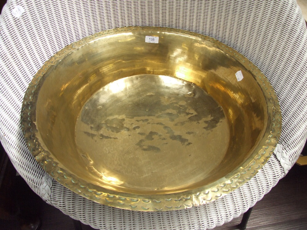 A large Eastern brass bowl of traditional design