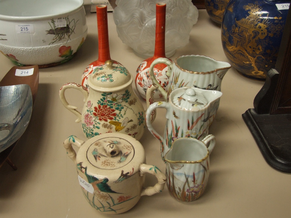 A pair of Satsuma bottle vases having slender necks, Satsuma tea and sucre pots and a Japanese