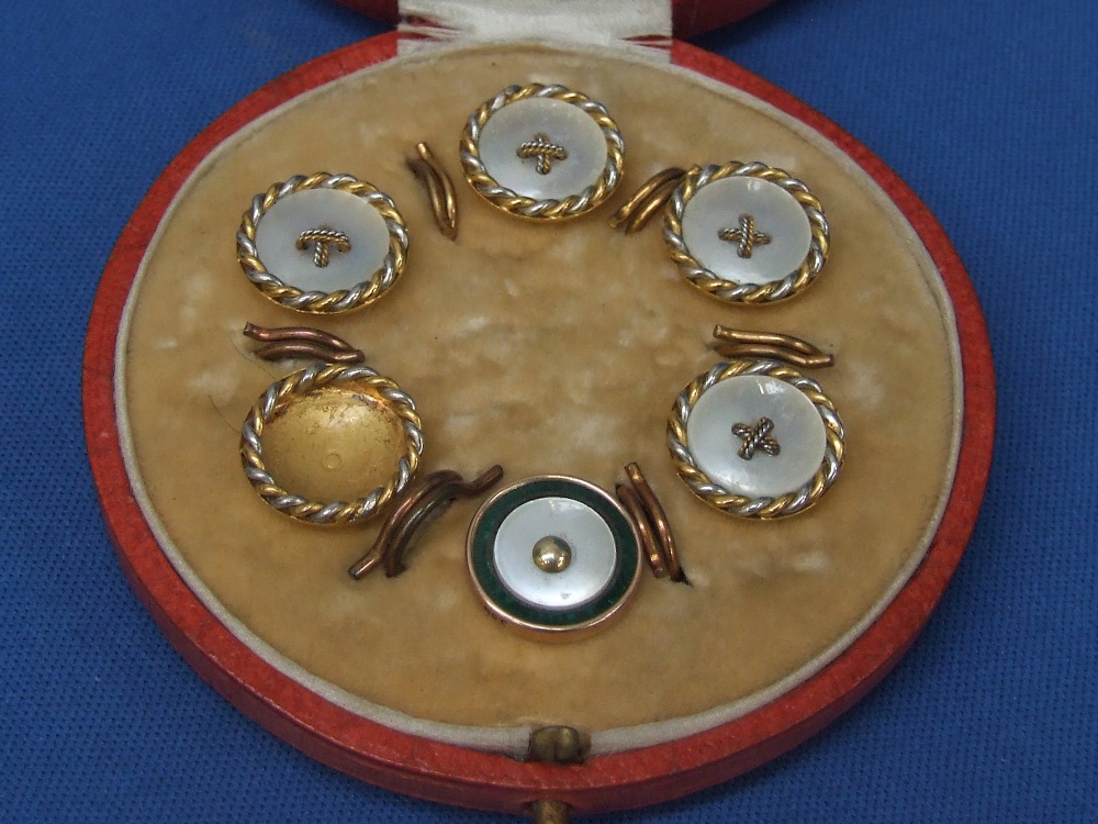 A cased yellow metal and mother of pearl button part set, stamped 15C and another similar button