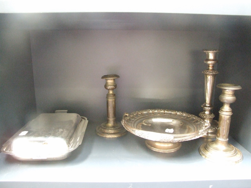 A plated fruit basket, candlestick, a pair of retractable candlesticks and a covered entree dish