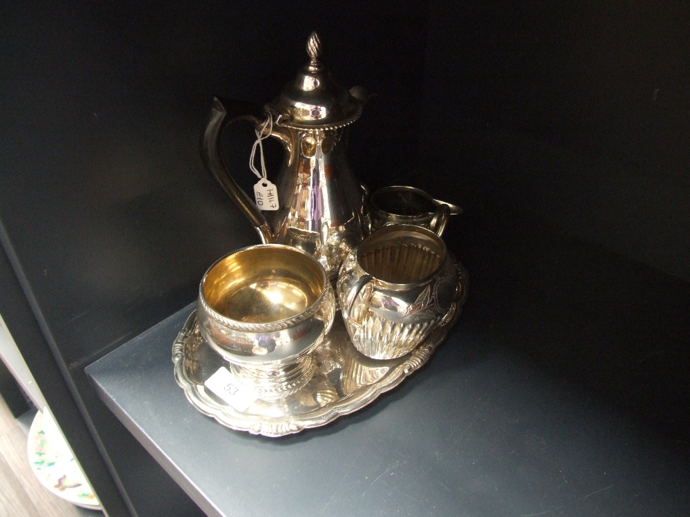 An Elkington plate hot water pot and sugar bowl of plain form and three items of plated ware