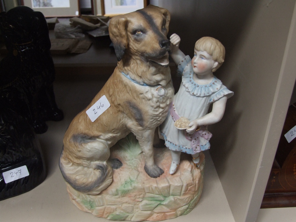 An early 20th century French bisque figure modelled as girl and dog