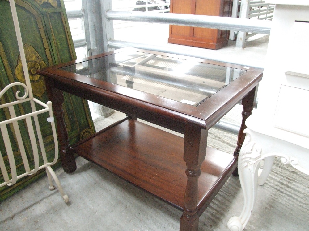 A modern mahogany effect glass coffee table