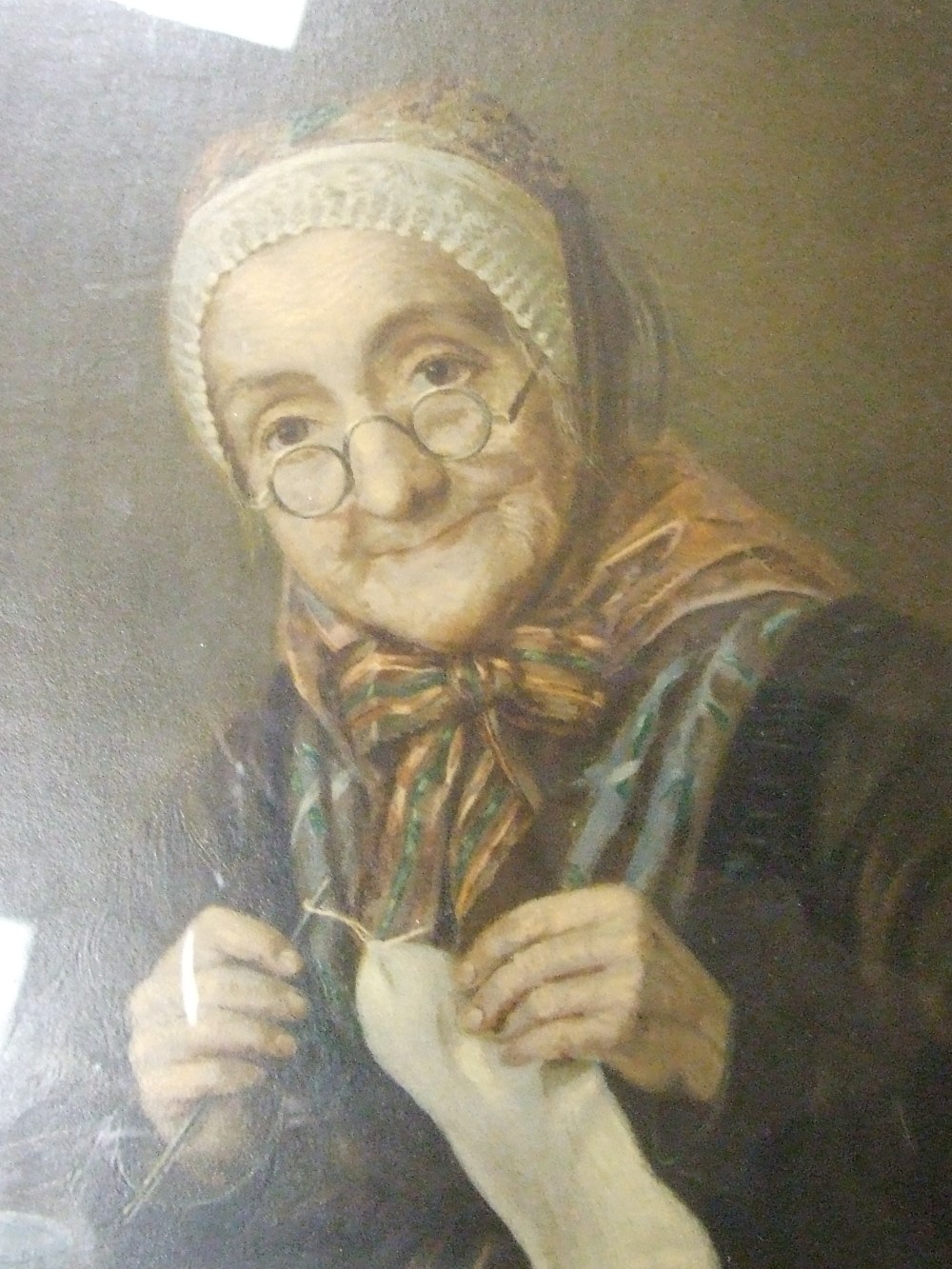 A chromolithographic print, Old Woman Sewing