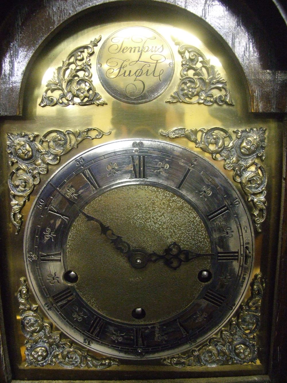 An early/mid 20th century oak granddaughter clock in the dwarf longcase style
