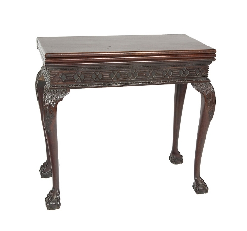 A GEORGE III STYLE MAHOGANY TRIPLE FOLDING TOP TEA AND GAMES TABLE, the games interior baize lined