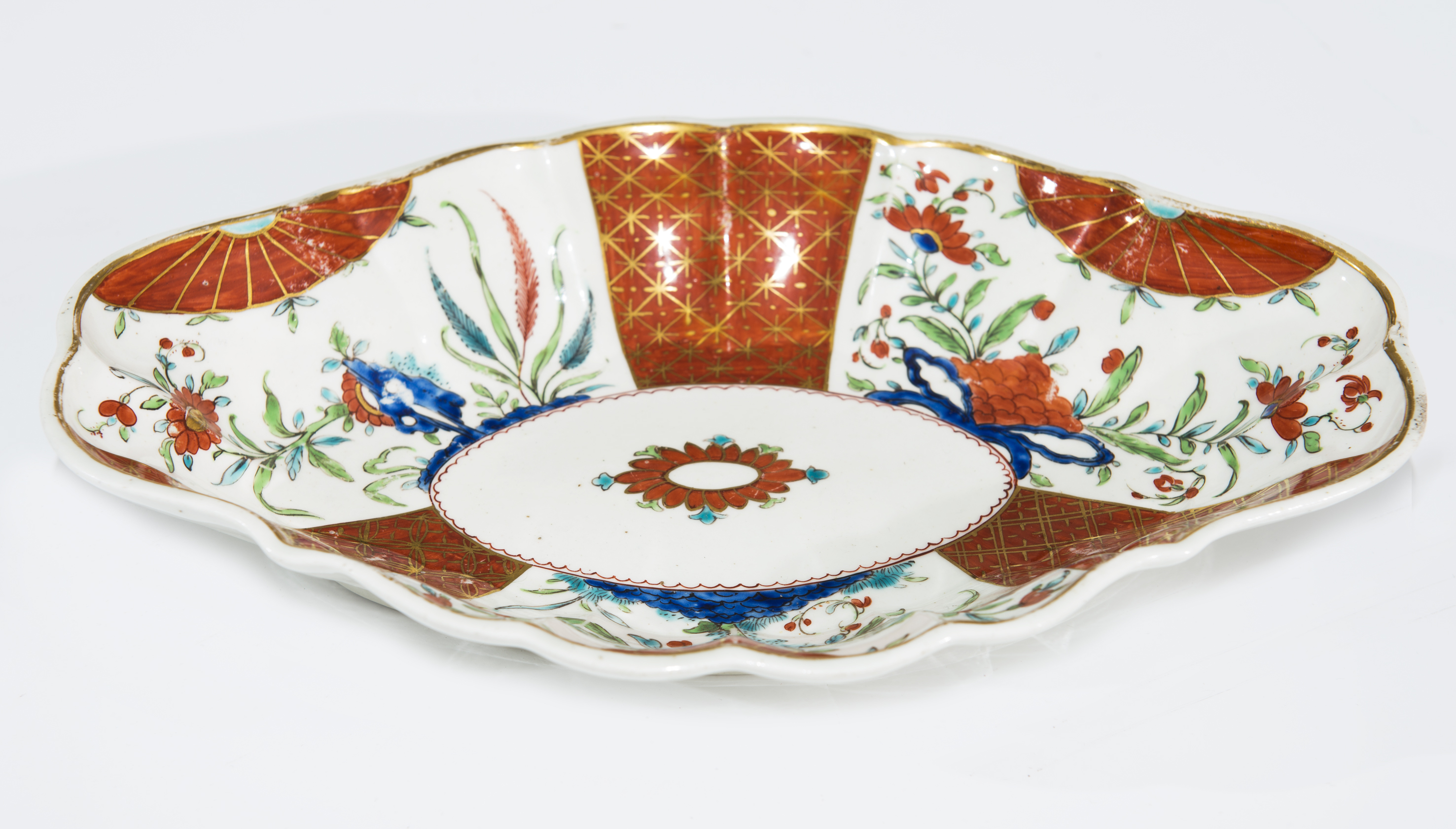 A RARE CAUGHLEY FLUTED LOZENGE-FORM DISH, late 18th century, painted with flowering stems and leaves