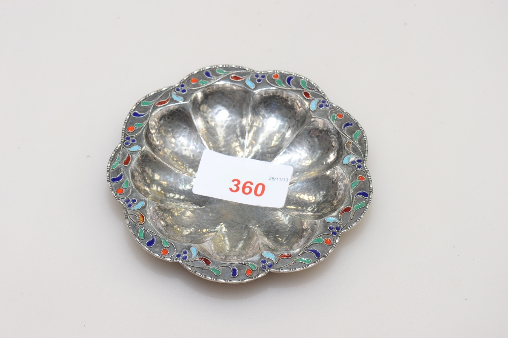 A Continental silver dish, of scalloped form, with enamel decoration, raised on three squat bun feet