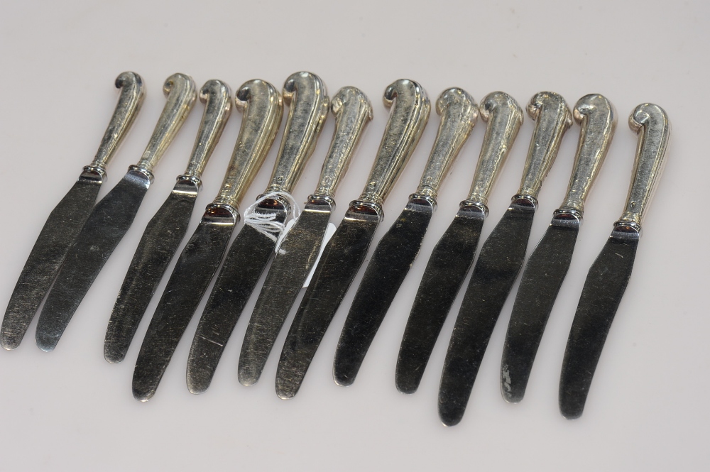 A group of twelve 19th century silver pistol-handled knives.