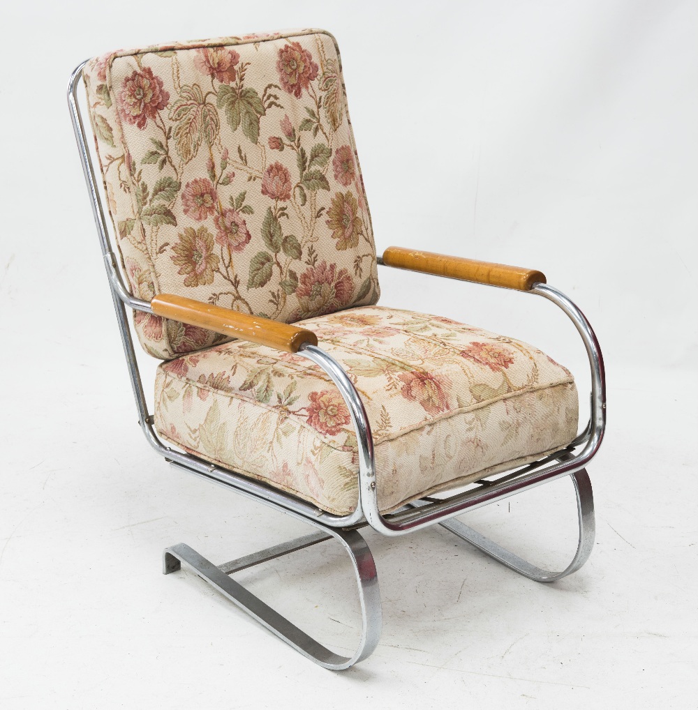 A 1970`s chrome-framed cantilever armchair, fitted with teak arms.