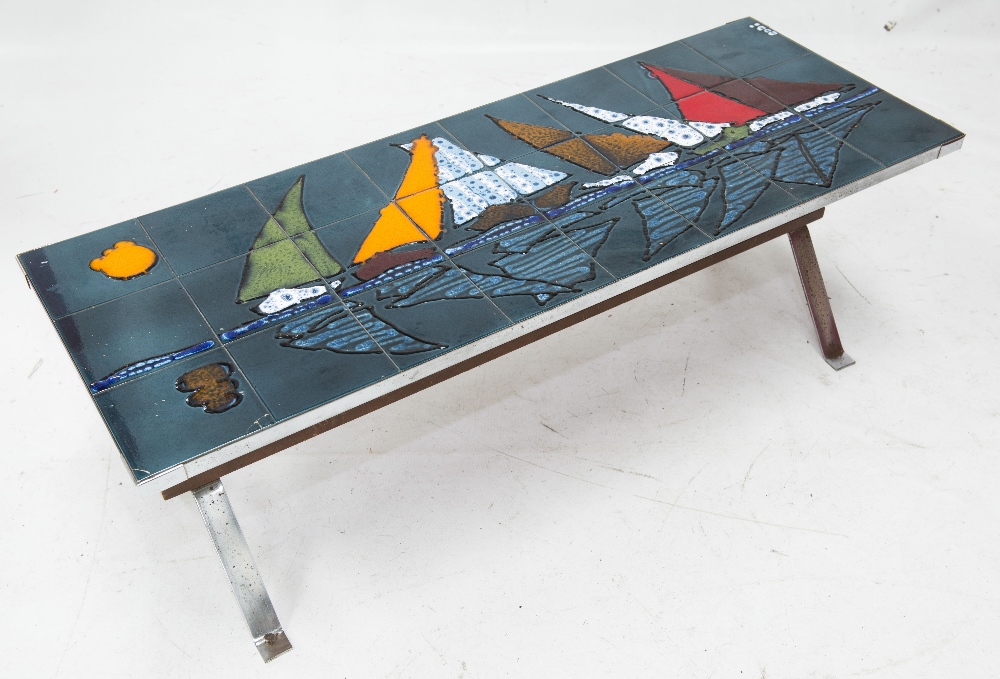 A 1970`s chrome tile top coffee table, decorated with sailing boats, signed (a/f).