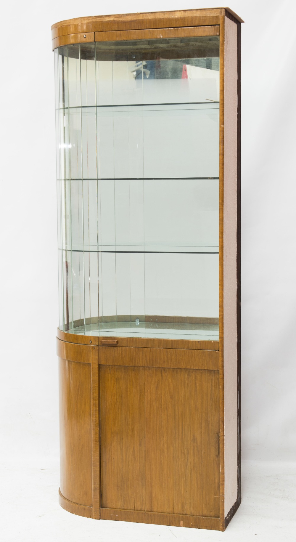 A mirror-backed glazed shop display cabinet with tambour door.