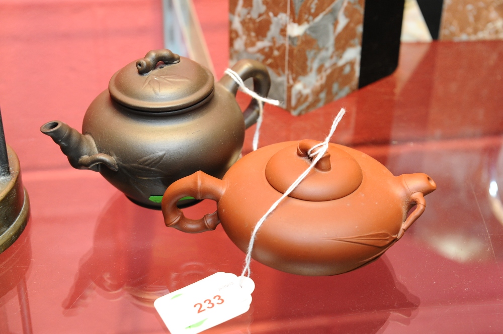 A 20th century Chinese terracotta squat teapot with `bamboo stick` handle bearing seal mark to base;