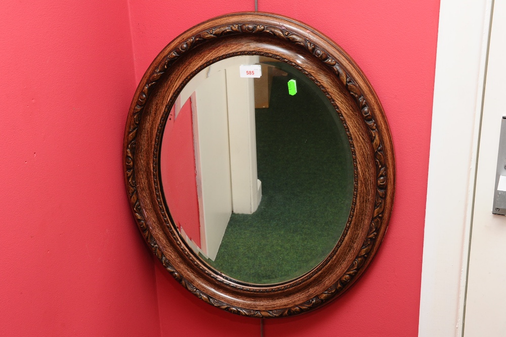 An oval oak mirror
