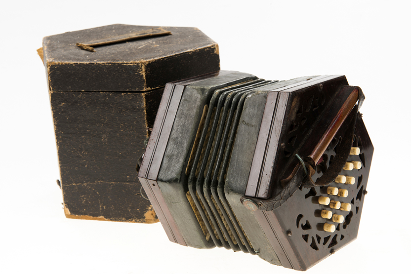 A LACHENAL STYLE CONCERTINA, with pierced rosewood hexagonal end plates with thirteen ivory keys