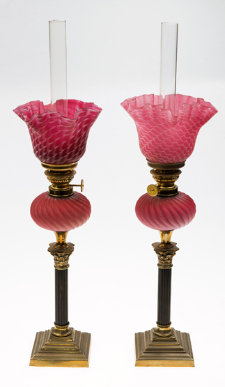 A PAIR OF 19th CENTURY BRASS PARAFFIN LAMPS, each with a pink satin glass shade and reservoir,