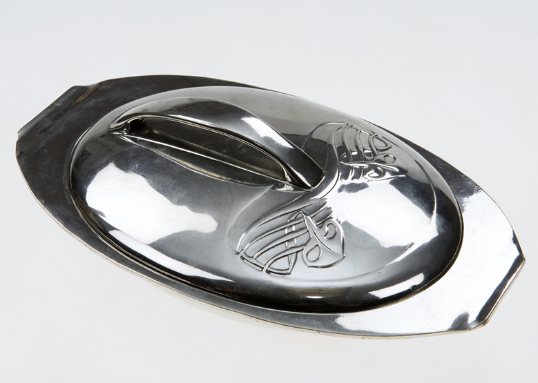 LIBERTY & CO. TUDRIC PEWTER MUFFIN DISH, DESIGNED BY ARCHIBALD KNOX, of oval form, the cover cast