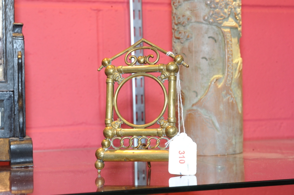 A Victorian brass pocket watch stand