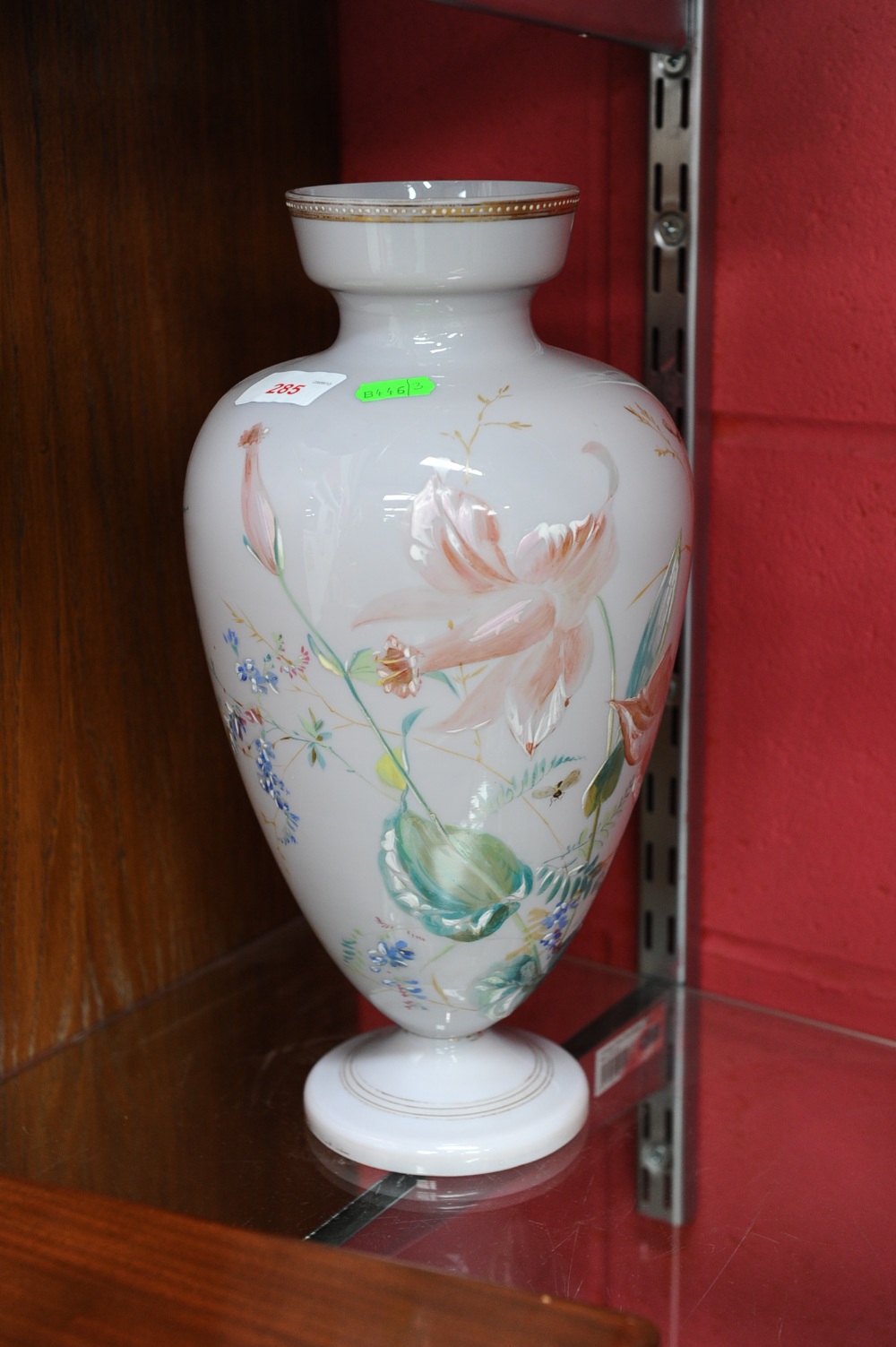 A Victorian cased glass vase decorated with lilies