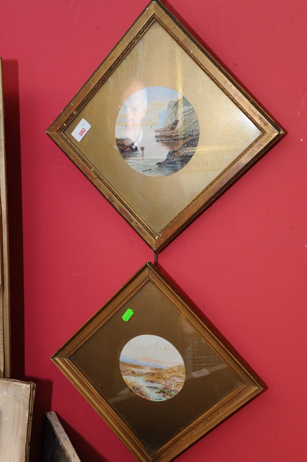 Two early 20th century circular watercolours of coastal scenes, initialed W.M. 1910, framed and