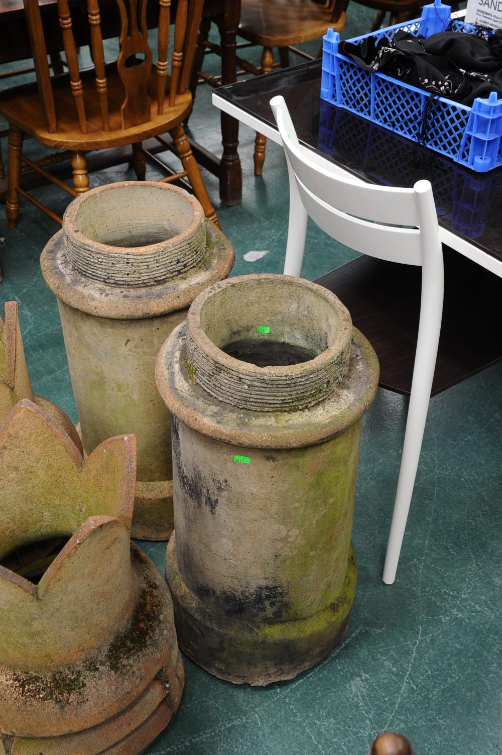 A pair of cylindrical chimney pots